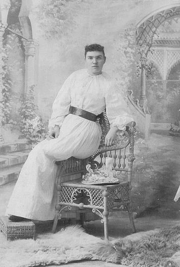 Unknown Lady in white on chair arm